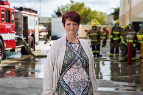 Dr. Andrea Pryce pictured in front of Fire Academy
